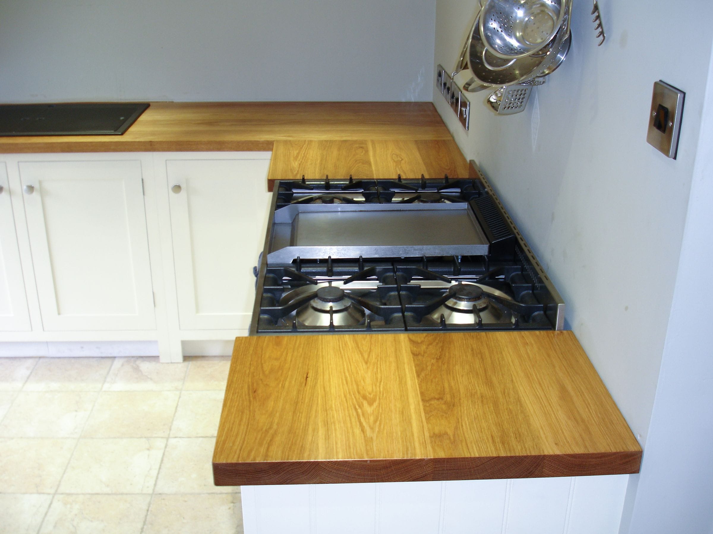 Oak super stave worktops fitted flush either side of an inset gas hob