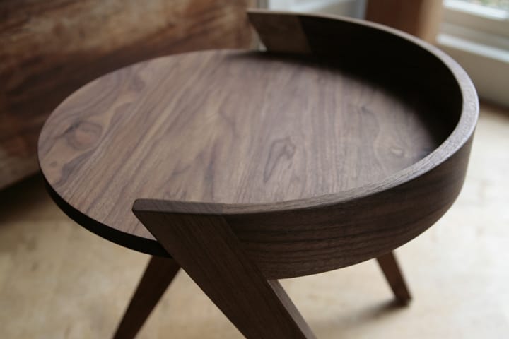 Round walnut side table with curved gallery rim and splayed legs