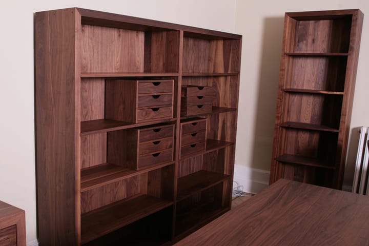 Bespoke walnut bookcases with fitted drawer boxes in a home office