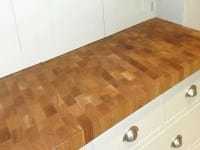 End grain butcher block worktop on white kitchen cabinets