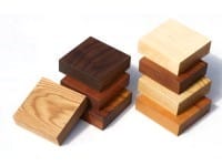 Stacked square worktop samples in assorted light and dark hardwoods