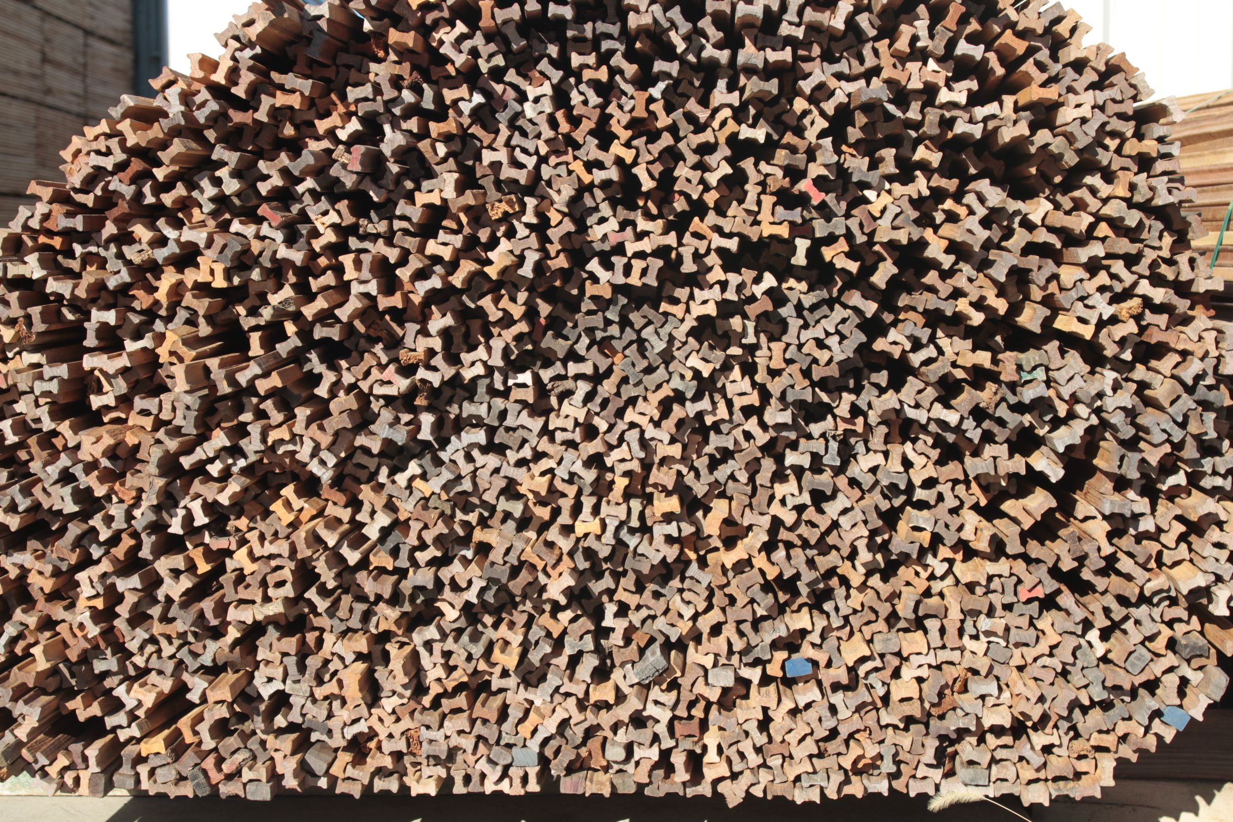 Stack of profiled timber lengths seen end-on in the timber yard