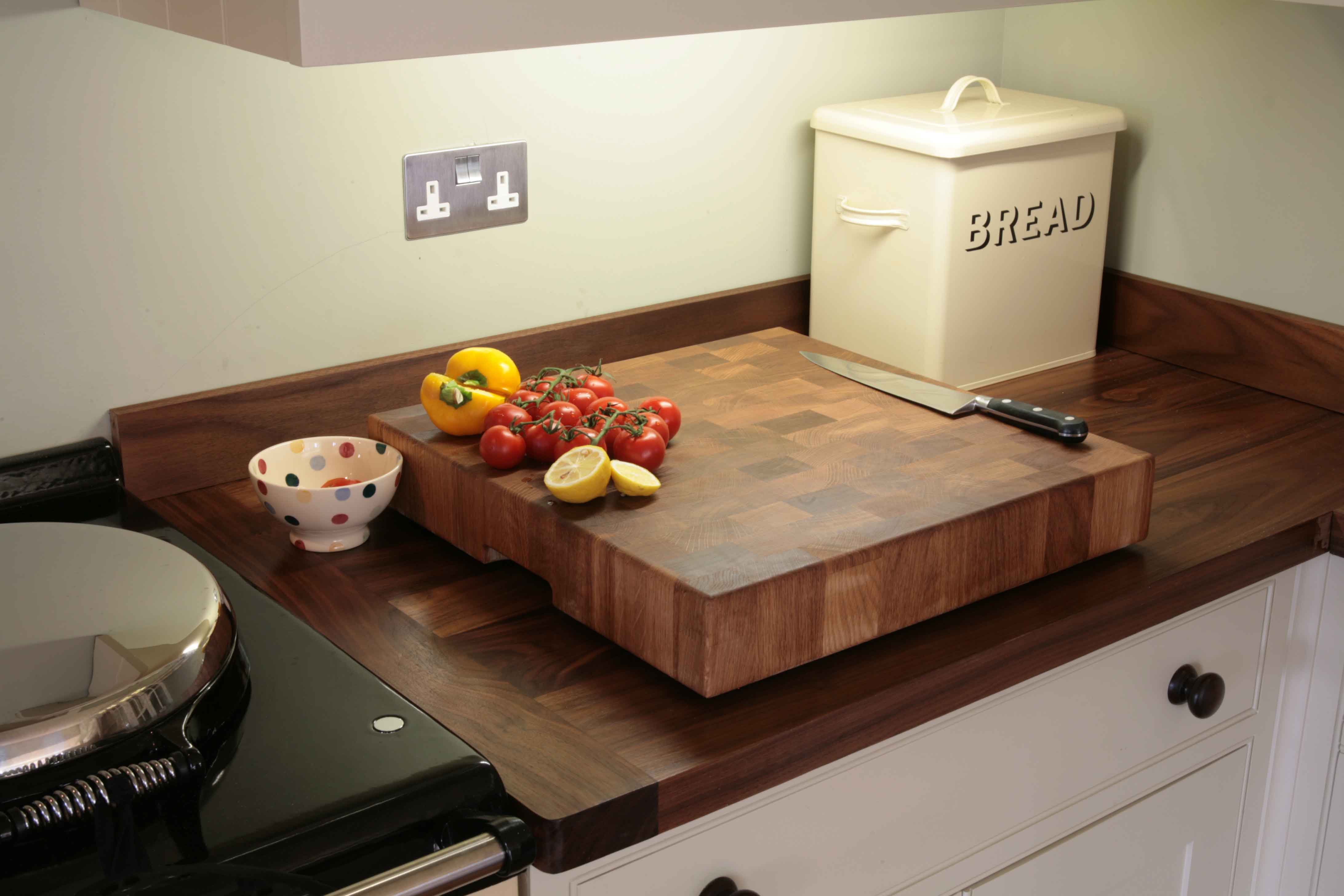 end-grain-chopping-block End-grain chopping block on a walnut worktop with fresh tomatoes, pepper and lemons