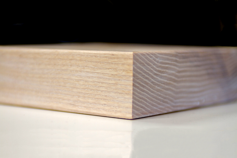 Corner detail of a limed oak worktop sample showing white-flecked grain
