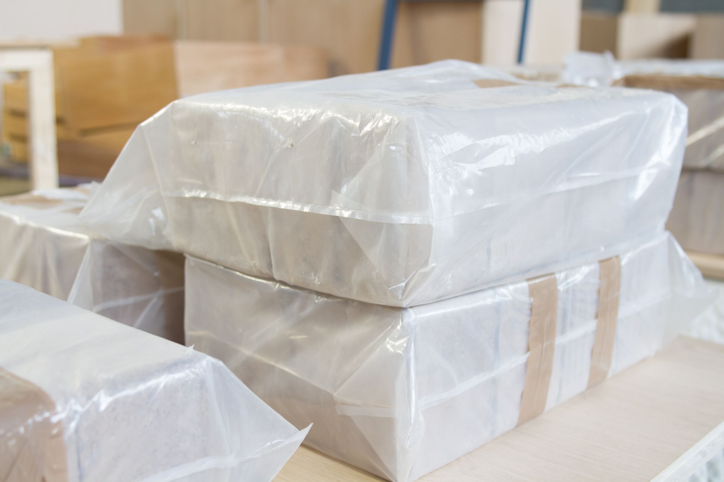 briquette bag Hardwood briquettes packaged in clear plastic bags stacked in the workshop