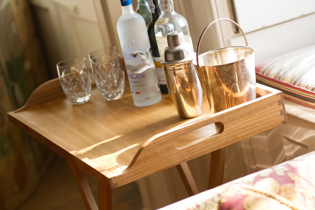 Oak butler's tray on folding stand set with cocktail shaker, ice bucket and glasses