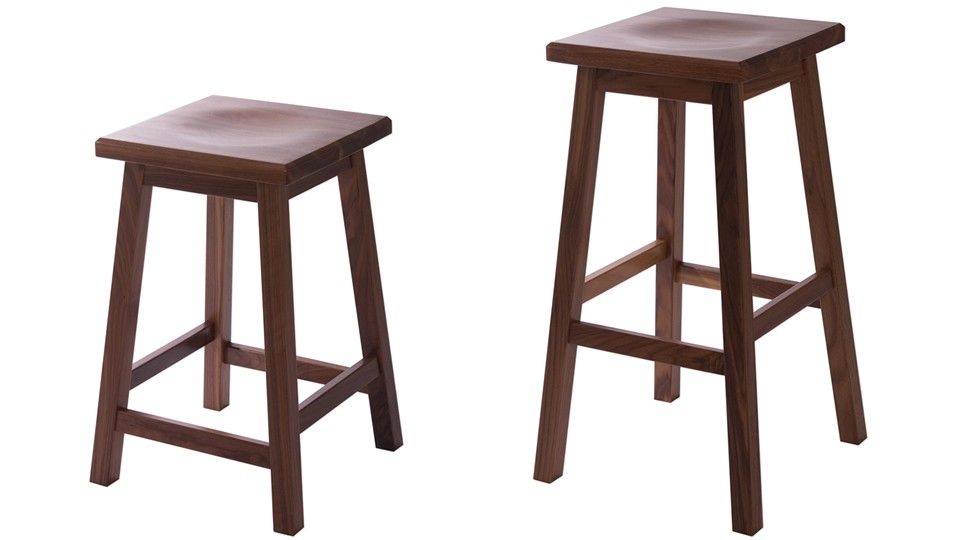 Pair of walnut stools in counter and bar heights with scooped seats