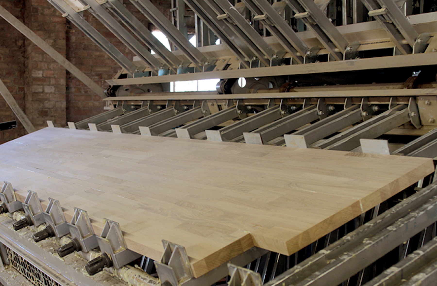 Unfinished oak worktop clamped in the bonding press at the Norfolk workshop