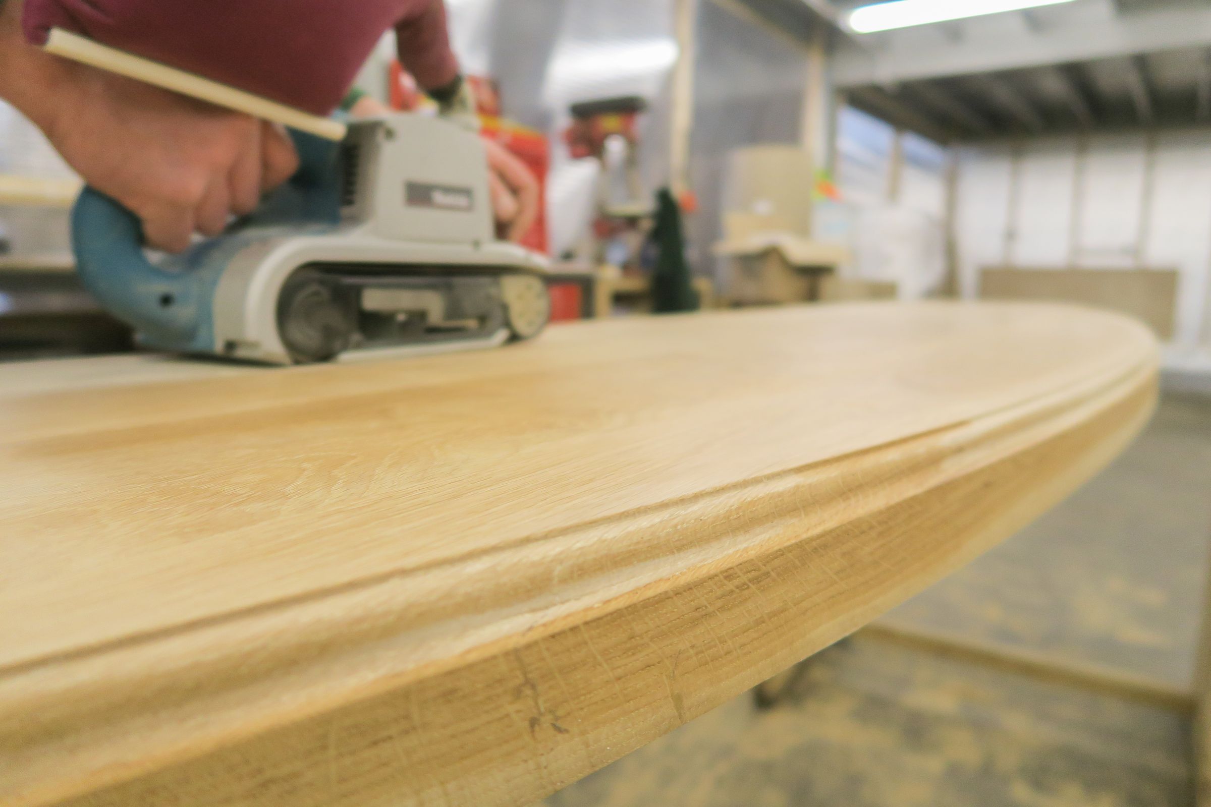 sanding oak worktop Belt sanding the edge of a curved oak worktop before finishing