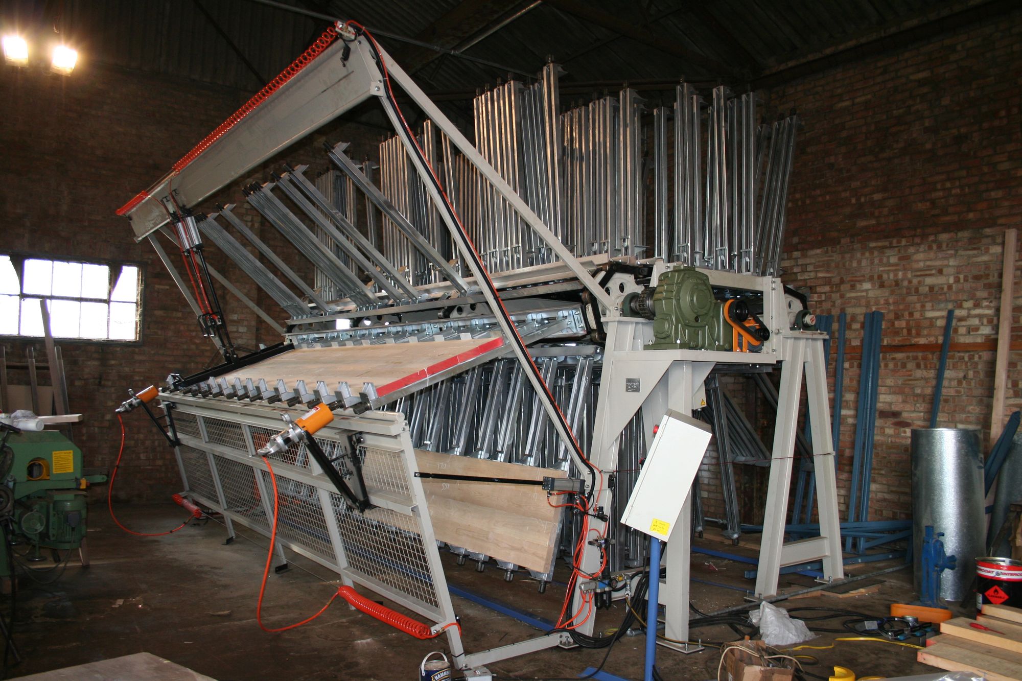 Rotary clamping carrier machine gluing worktop staves in the brick-walled workshop