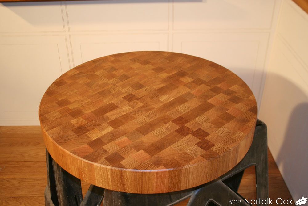 Round oak end grain chopping block with chequered grain pattern